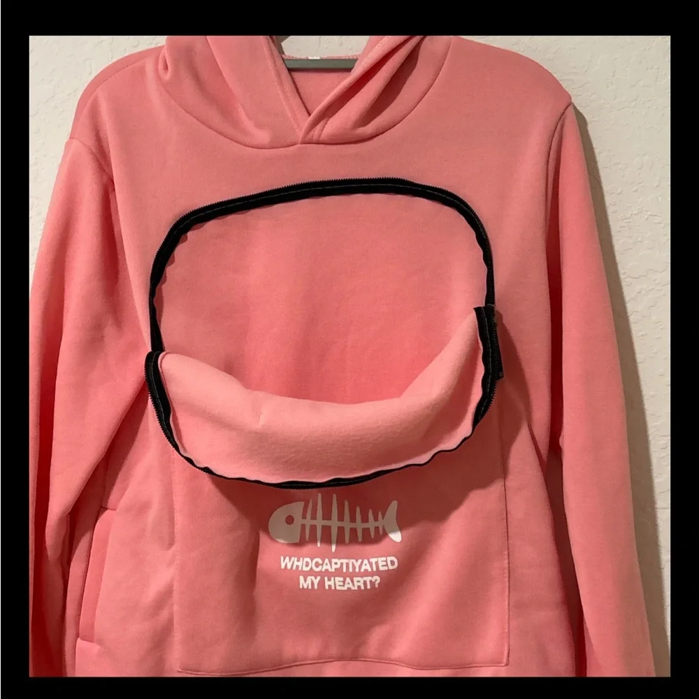 Pink sweatshirt that you can hold a small pet in.